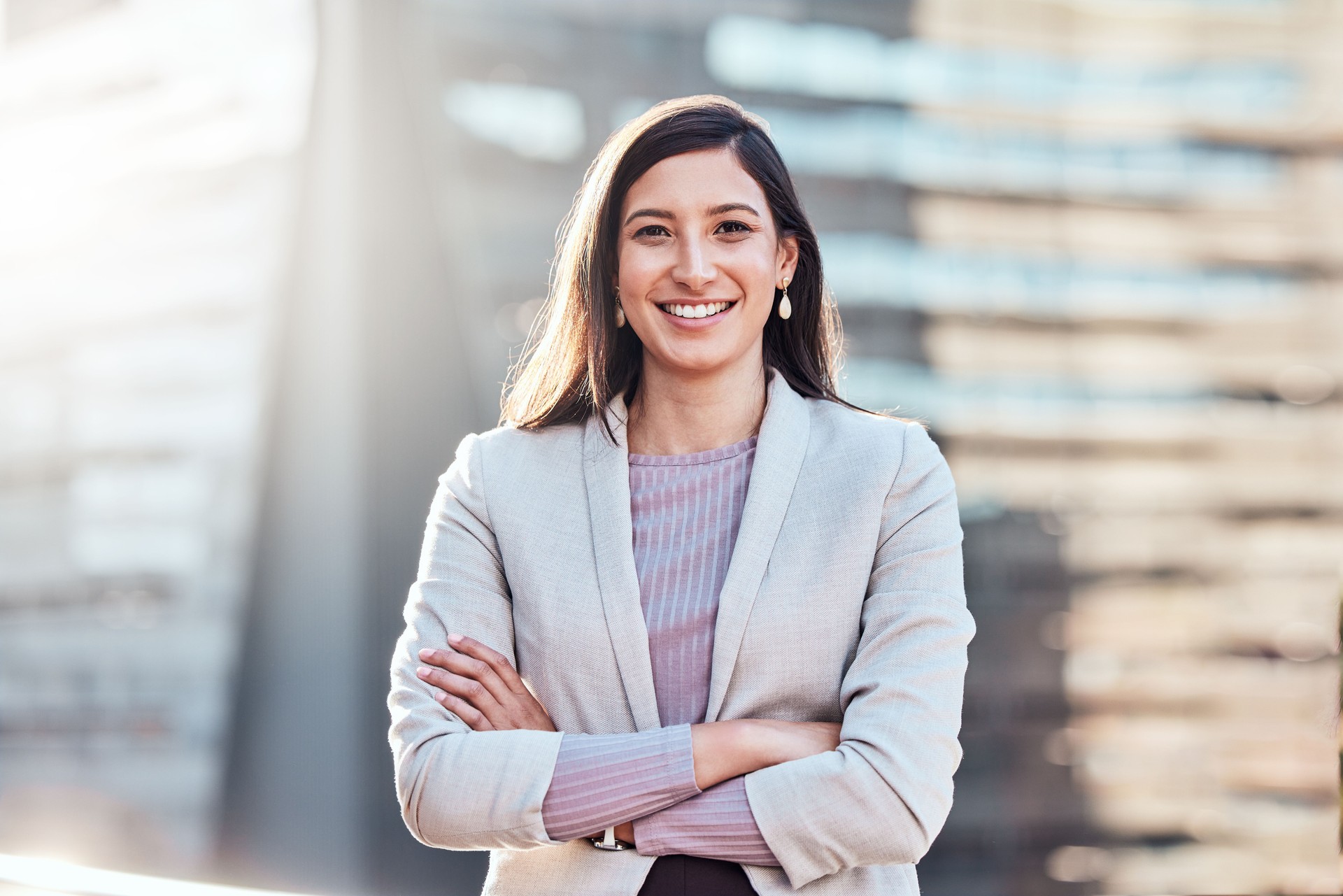 Shot of an attractive young businesswomen standing alone outside with her arms folded